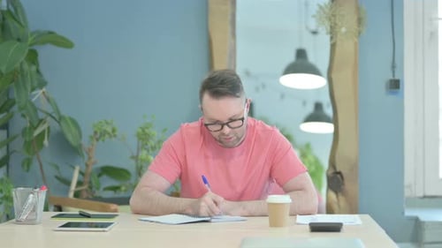 Creative Man Writing while Sitting
