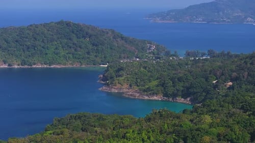 Aerial View of a Pristine Beach on Phuket Island Thailand with Turquoise Waters Lush Green Hills