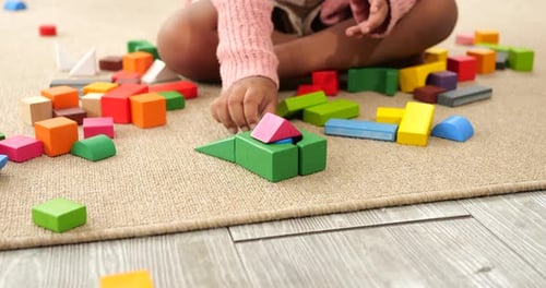 Daughter playing colorful wooden block toys