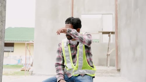 Indian foreman had a mustache. Sit down after hard work on construction, exhausted from work. The we