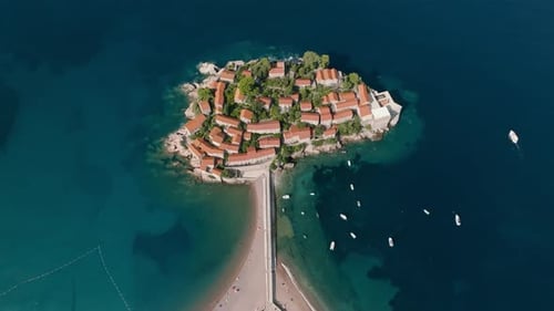 A drone view from above of the island of Sveti Stefan in Montenegro, connected to the mainland by a