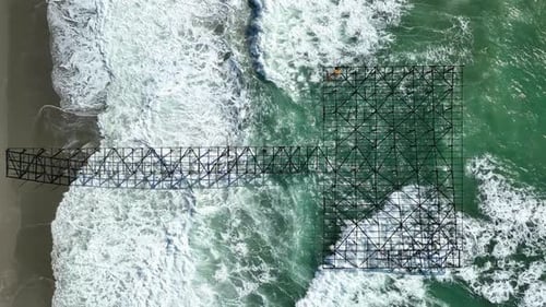 Old Dismantled Pier Aerial View in Slow Motion Strong Storm on the Coast Big Waves in Slow Motion
