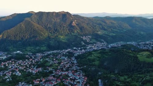 View From Rock to Town of Smolyan with Meadows for Cattle Walking and Houses Between Mountain Range