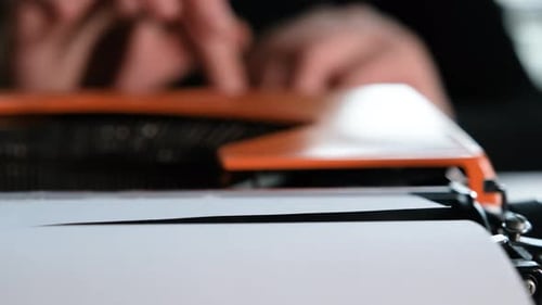 Woman typing on retro typewriter