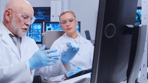 Scientists Discussing Medical Research in Modern Laboratory