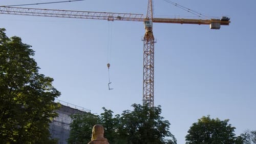 A View of a Construction Crane Against a Backdrop of Blue Sky in Baden-Baden, Germany - Low Angle Sh