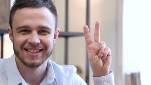 Victory Sign By Young Man