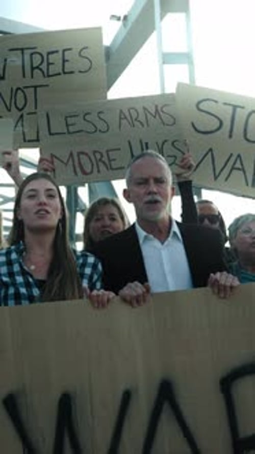 Group Protests War with Signs at Outdoor Rally