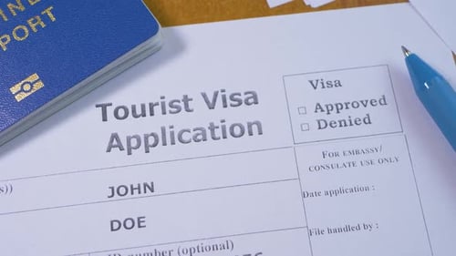 Approved Visa Application with Passport and Pen