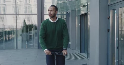 Multiracial Businessman in Casual Wear Suit Riding Electric Scooter While Commuting to Work