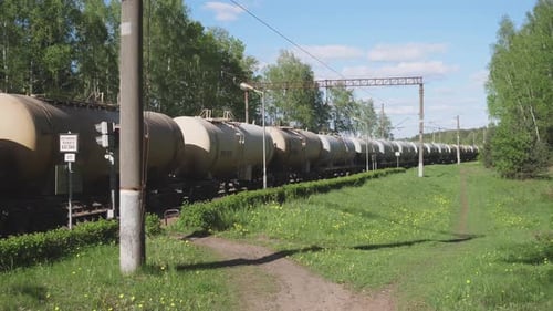 Freight Train Moving Through Rural Countryside on Sunny Day