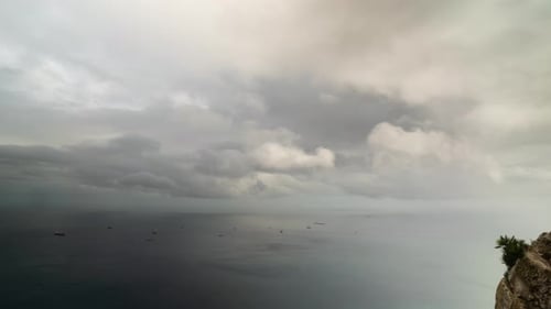 Ocean and Ships Under Cloudy Sky