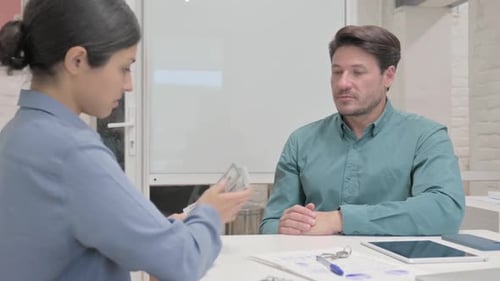 Indian Woman Gives Money to Businessman
