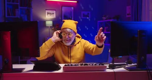 Man Using Sound Mixer in Neon Lit Room