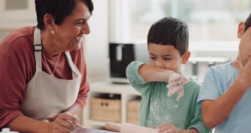 Woman and Children Baking Together in Kitchen