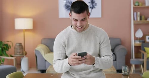 Couple Laughing at Smartphone in Living Room