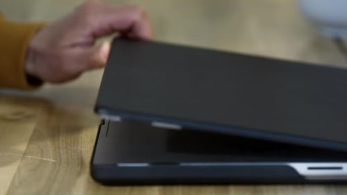 An Old Man Opens a Laptop in a Restaurant Remote Work of a Freelancer in a Coworking Grandpa is an