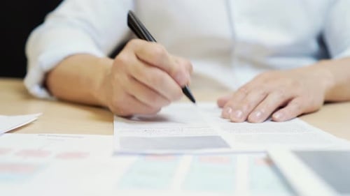 Closeup, Businessman signing a contract investment professional document agreement on the table