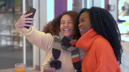 Two Young Women Taking a Selfie Together