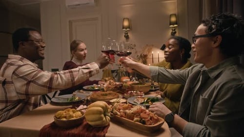Friends Enjoy Festive Meal and Toast with Wine