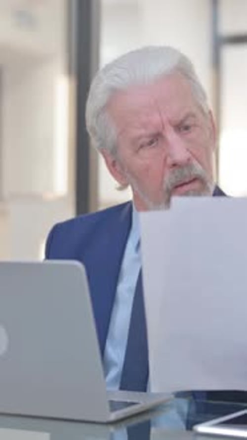 Senior Man Celebrating Success While Using Laptop