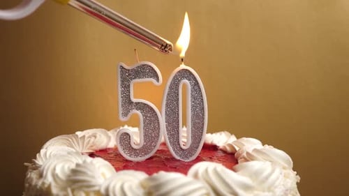 50. A candle in the form of the number 50 is lit, which is stuck into the holiday cake. Celebrating