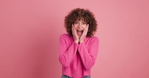 Woman Surprised and Clapping in Studio Setting