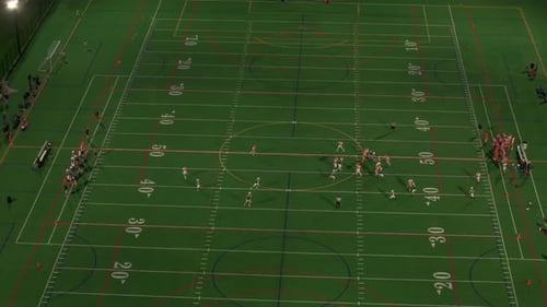 American Football Teams of Play at Night Time Move Aerial View