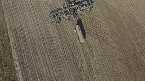 Big red combine working on the field cultivating and applying nitrogen ASP