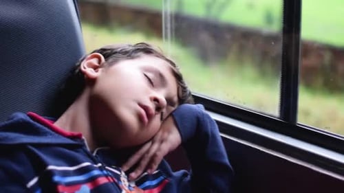 small child sleeping in a train