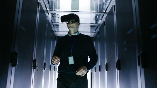 IT Engineer Wearing Virtual Reality Headset Works with Augmented Reality Software in Data Center. H