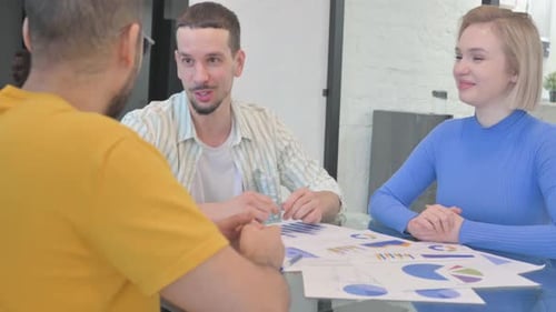 Business Professionals Discussing Data at Office Meeting