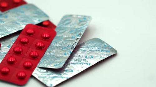 Red Pills Blister Pack on a White Surface