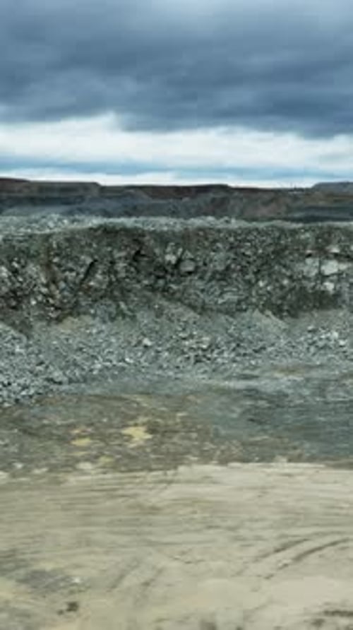 Mining Excavator Loading Ore Into a Dump Truck in Open Pit Mine Stock Clip