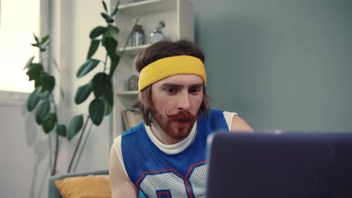 Young Adult Lifting Weights While Using Laptop