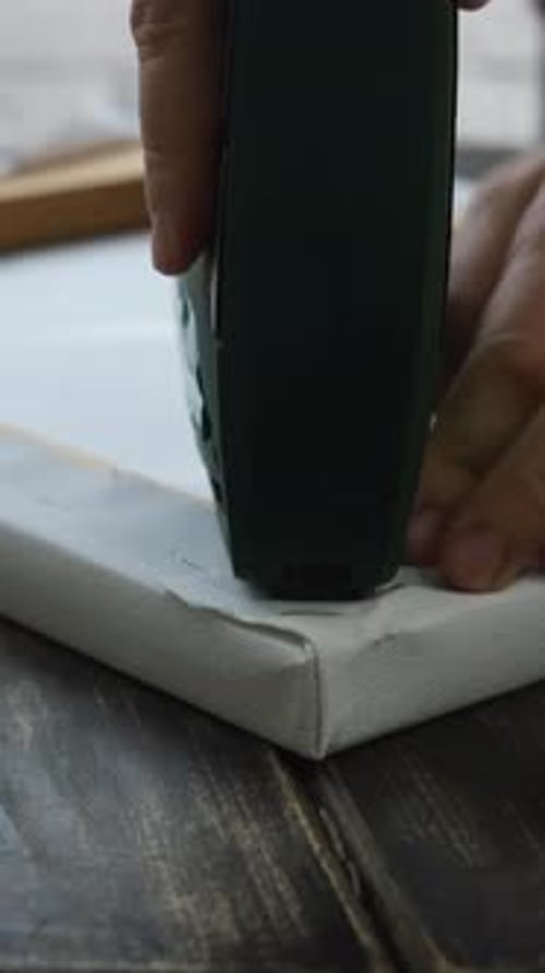 Canvas Being Attached to Frame with Staple Gun