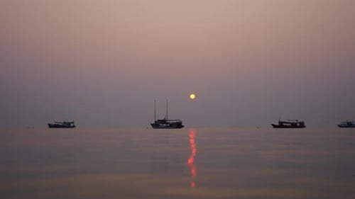 Boats in the Background at a Beautiful Sunset at Sea