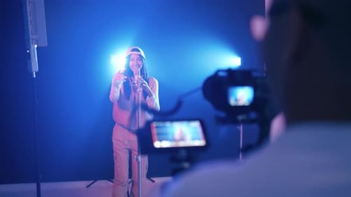 Cameraman Filming Young Female Singer Rapping in Studio