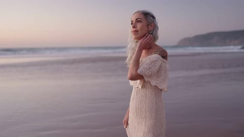 Beautiful Senior Woman Walking on Beach at Dusk Contemplation Hope and Serenity