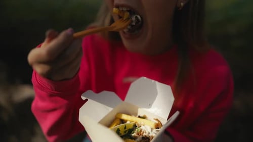 Young Woman Enjoys Loaded Fries Outdoors