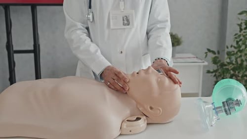 Medical Professional Demonstrating CPR Training on Mannequin