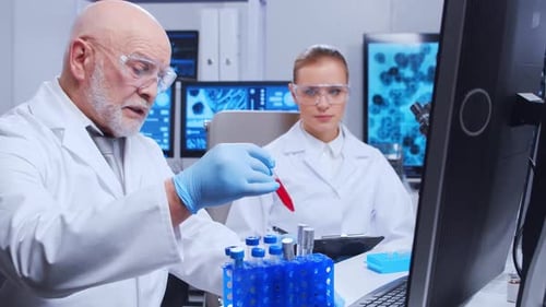 Elderly Professor and Young Laboratory Assistant are Doing Scientific Experiment in a Modern
