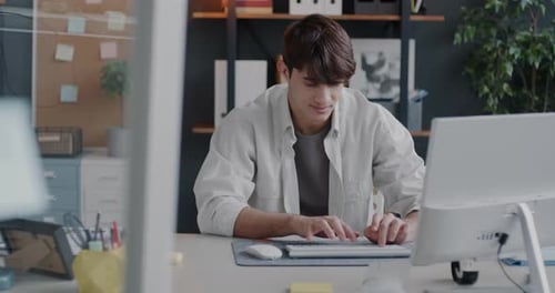 Middle Eastern Man Office Employee Working with Computer Typing Sitting at Desk in Workplace