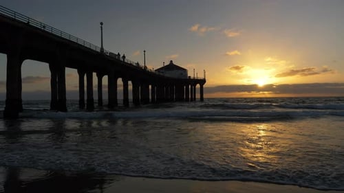 Golden hour tracking shot along santa monica beach at sunset in California
