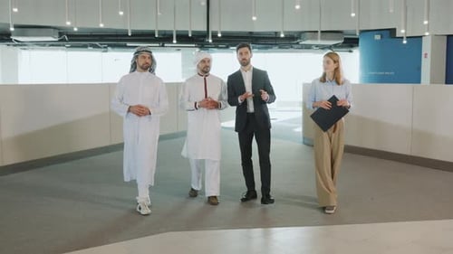 International Group of Muslim Investors and Caucasian Office Couple Communicating About Enterprise
