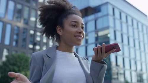 Young Businesswoman Recording a Voice Message in City