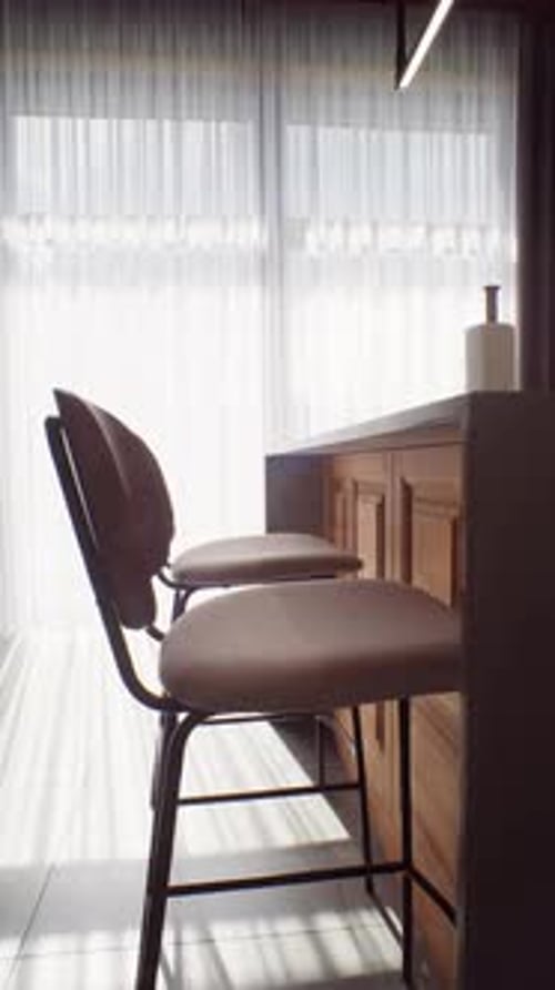 Elegant Armchair Silhouetted At Bright Terrace Doors