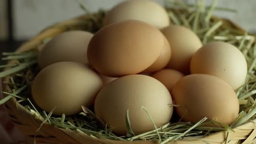 Brown Eggs in Straw-Lined Basket Close Up