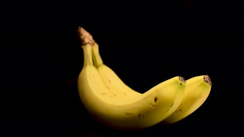 Yellow Bananas Rotating on Black Background