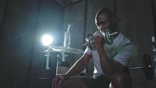 Fitness Workout in Gym African American Man Bodybuilder Picking Up Dumbbells in Gym Workout Weight